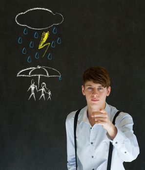Insurance businessman protecting family from natural disaster on blackboard background
