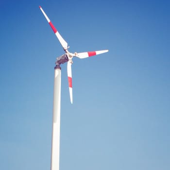 Windmill and blue sky with retro filter effect