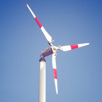 Windmill and blue sky with retro filter effect