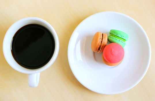 Colorful macaroons and a cup of coffee