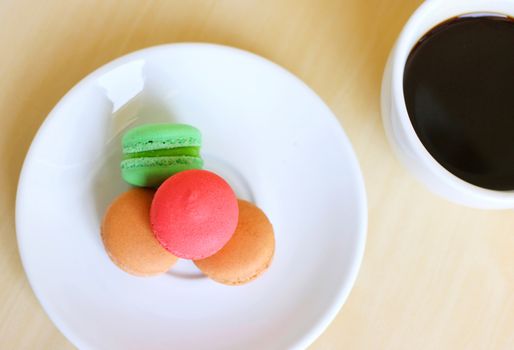 Colorful macaroons and a cup of coffee