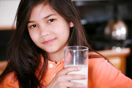 Beautiful young biracial girl drinking milk