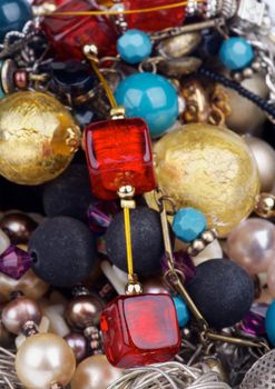 Background of Various Jewelry with Gold Bracelets, Ruby Necklace, Pearl and Gem Beads closeup