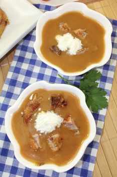 white bowls with duck soup and cream