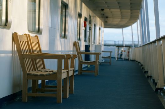 Wooden chairs on the deck of the cruise liner