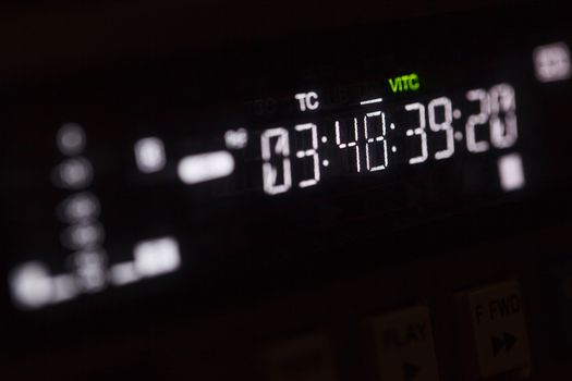 Timecode running on the professional video recorder. Macro shot with perspective.