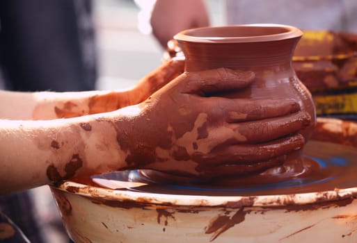 Potter making the pot in traditional style. Close up.
