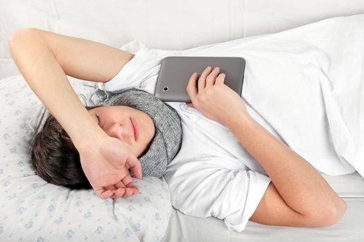 Sick Teenager sleeps with Tablet Computer