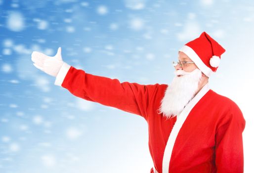 Santa Claus shows the way with a hand on the Abstract Winter Background