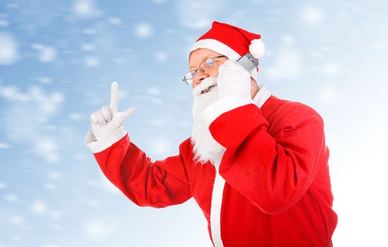 Cheerful Santa Claus talking on Cellphone on the Abstract Winter Background