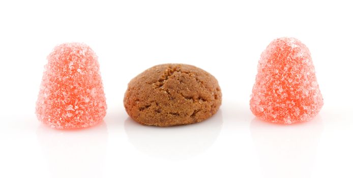 Pepernoot (ginger nuts) and tumtum candy over white background