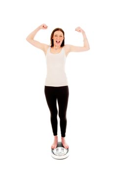 a girl on a weighing scale, celebrating her success of loosing weight