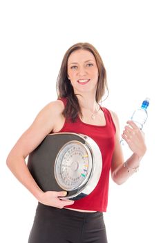 a girl with a weighing scale and a bottle of water,  celebrating her success of loosing weight