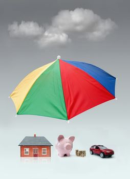 Umbrella shielding a home, car and money from dark clouds 