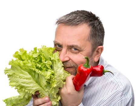 Healthy food. Joy of vegetarianism. A man with a salad and red pepper. Isolated on white