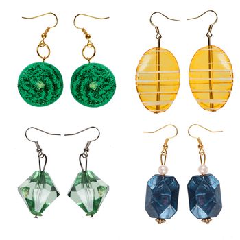 Earrings  made of plastic and glass   isolated on white background. Collage.
