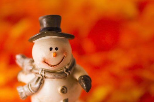 Happy snowman with hat and gloves on red background