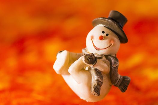 Happy snowman with hat and gloves on red background