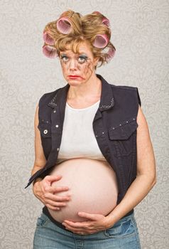 Suspicious pregnant woman in curlers and makeup