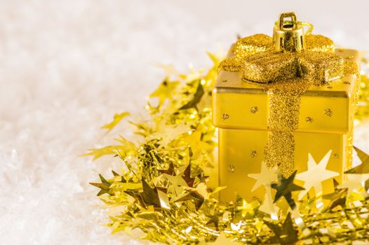 Golden Christmas decoration on golden tinsel