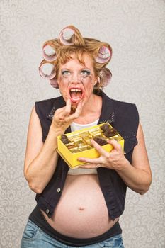 Pregnant hillbilly pigging out on box of candy