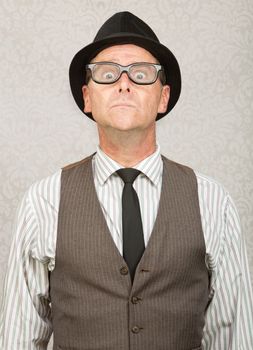 Frightened white businessman with hat and eyeglasses