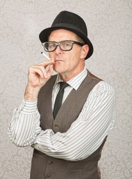 Skeptical white businessman with hat smoking a cigarette
