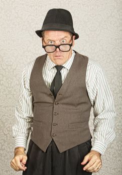 Dumfounded businessman with hat and eyeglasses