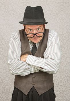 Single mad businessman with hat and folded arms
