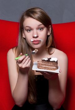 Cheerful woman eating pie