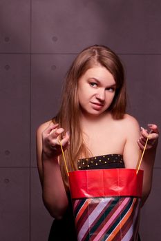 The beautiful fashionable young woman considers gifts