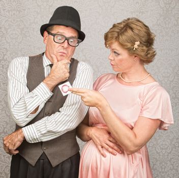 Worried man in hat with pregnant woman holding contraceptives