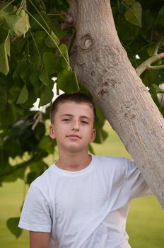 Portrait of a cute young boy outside .