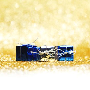 Christmas gifts close-up on golden background
