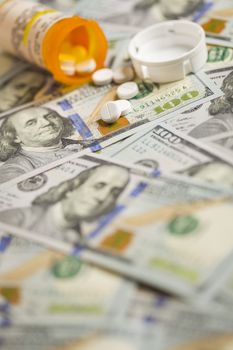 Medicine Pills Scattered on Newly Designed U.S. One Hundred Dollar Bills.