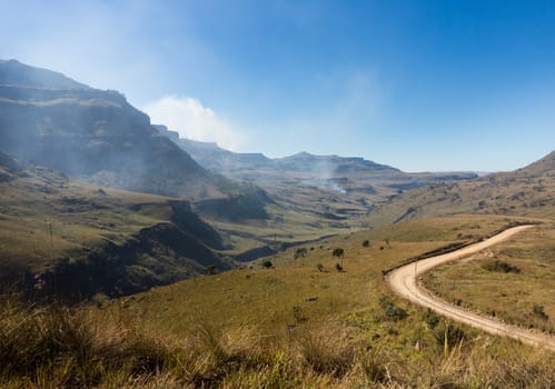 Valley and winding road over mountains from South Africa to Lesotho over Sani Pass