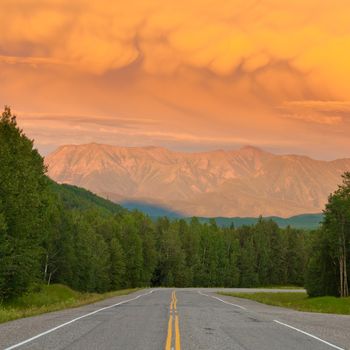 Liard River valley Alaska Highway British Columbia Canada sunset light on approaching summer thunderstorm clouds