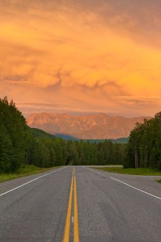 Liard River valley Alaska Highway British Columbia Canada sunset light on approaching summer thunderstorm clouds