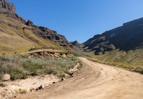 Valley and winding road over mountains from South Africa to Lesotho over Sani Pass