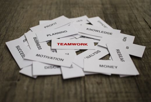Paper strips with Teamwork related words on wooden background