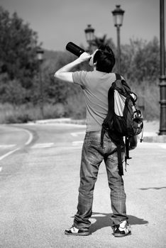 Drunkard walking around the streets boozing from a bottle