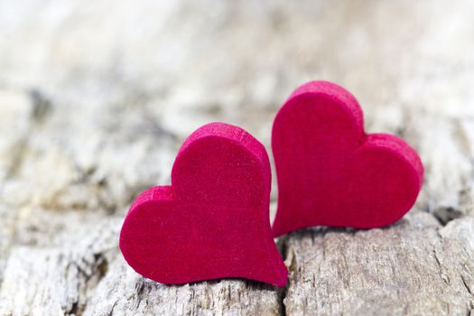 two red hearts on wooden background