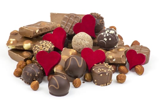 delicious chocolate and hearts on white background