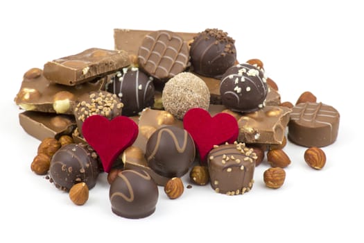 delicious chocolate and hearts on white background