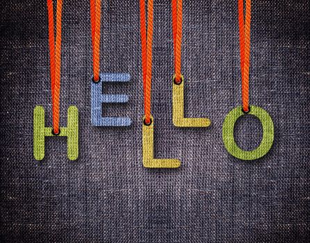 Hello Letters hanging strings with blue sackcloth background.