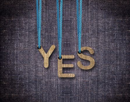Yes Letters hanging strings with blue sackcloth background.