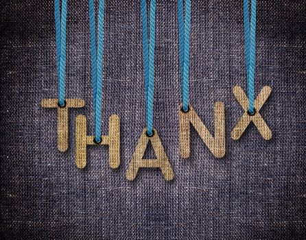Thanks Letters hanging strings with blue sackcloth background.