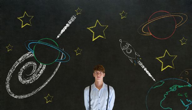Businessman with chalk universe planet solar system on blackboard imagining space travel