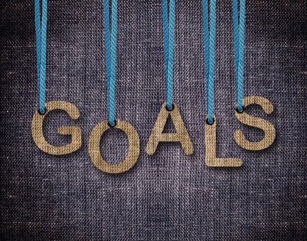 Goals Letters hanging strings with blue sackcloth background.