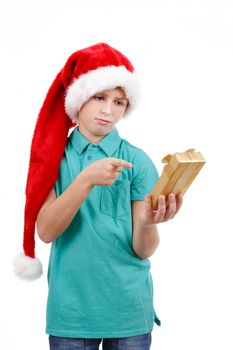 happy teenage boy with santa claus hat isolated on white and showing his christmas gift